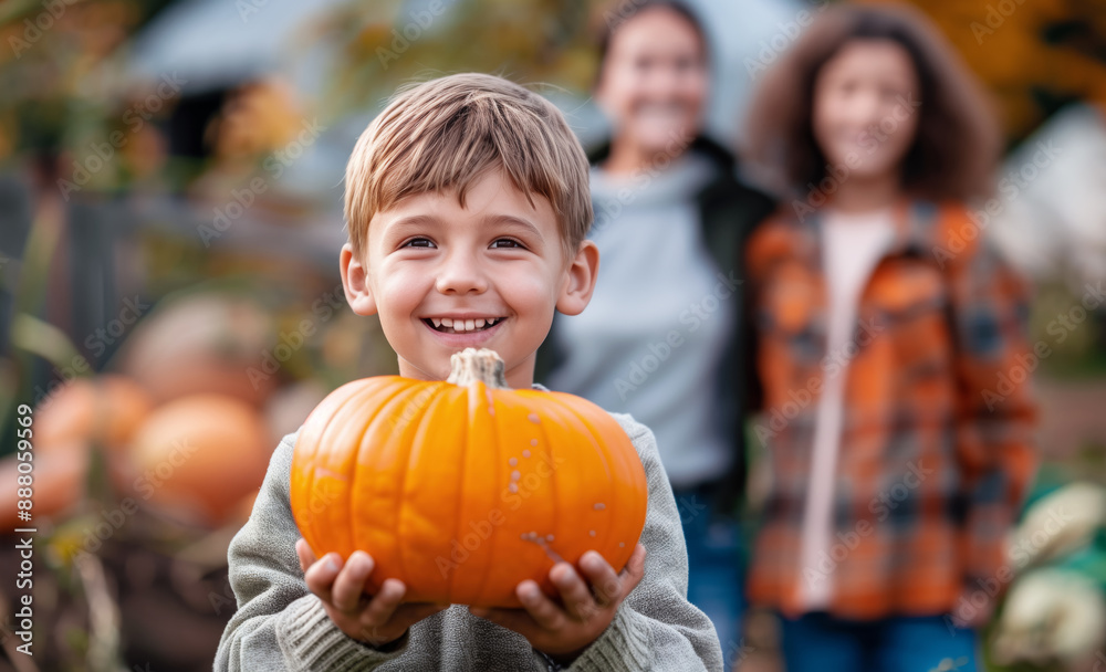 Fototapeta premium Smiling boy carries orange pumpkin from autumn garden with his smiling parents in background fall harvest family activity scene, joyful moment, outdoor fun, seasonal tradition, warm colors happy child