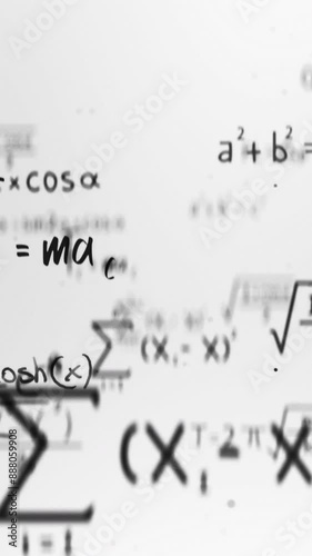 Vertical Animation of typing mathematics and physics formulas in abstract digital space. White on background seamless looping