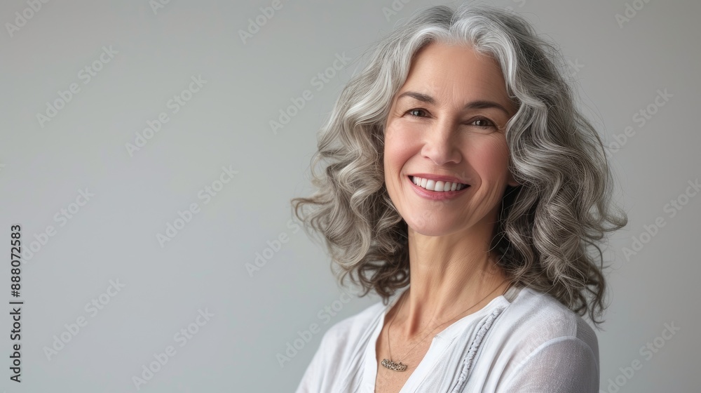 Fototapeta premium Grey-Haired Lady Poses in Studio Setting