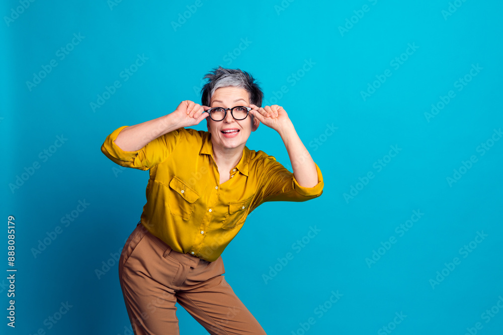 Photo of excited positive woman wear blue blouse eyeglasses looking you empty space isolated blue color background Photo of excited positive woman wear blue blouse eyeglasses looking you empty space isolated blue color background