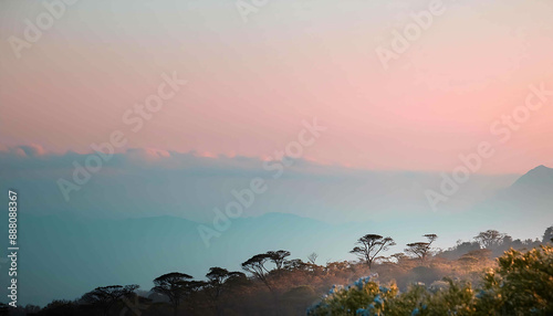 Mountain sunrise paints the sky with vibrant colors as golden light bathes the peaks
