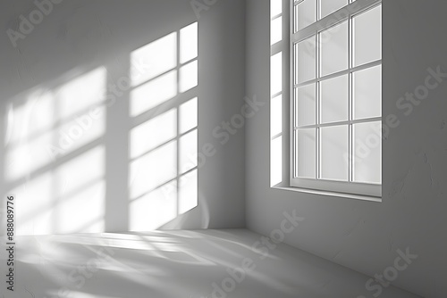 Sunlight Streaming Through a Window Casting Shadows on a White Wall