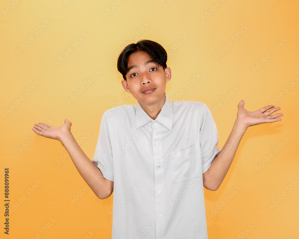 Portrait of an Asian man raised both hands, expressing that he was questioning something. Portrait of an Asian man raised both hands, expressing that he was questioning something.
