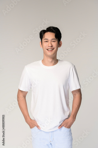 Portrait of young smiling asian man over white background © tonefotografia