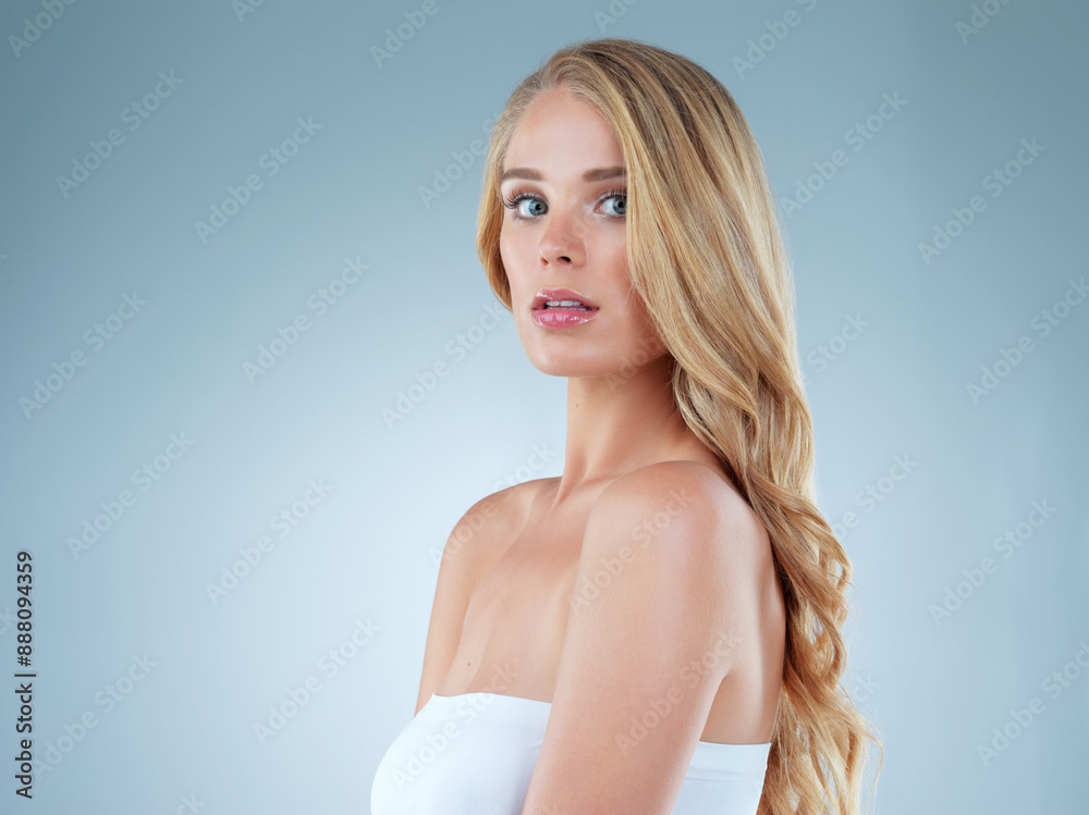 Girl, portrait and hair care in studio backdrop for cosmetics with volume, confidence and trendy style. Female person, growth and shine in isolated, keratin and texture for beauty in blue background Girl, portrait and hair care in studio backdrop for cosmetics with volume, confidence and trendy style. Female person, growth and shine in isolated, keratin and texture for beauty in blue background