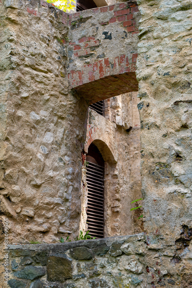 stone wall has a window with a wooden frame stone wall has a window with a wooden frame