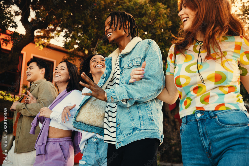 © Jacob Lund - Group of friends laughing and enjoying summer outdoors