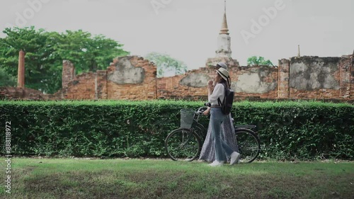 Tourist travel taking a bicycle in Ayutthaya historical Park UNESCO world heritage site.