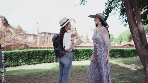Tourist Travel with guide in temple on Ayutthaya historical Park UNESCO world heritage site.