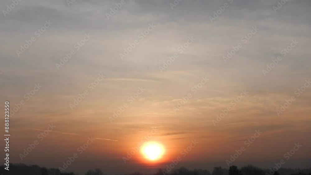 Orange and blue sky, sunrise and misty horizon of mountains and dark trees on autumn and winter season - natural calm scene. Topics: weather, dawn, sky, atmosphere, air, meteorology Orange and blue sky, sunrise and misty horizon of mountains and dark trees on autumn and winter season - natural calm scene. Topics: weather, dawn, sky, atmosphere, air, meteorology