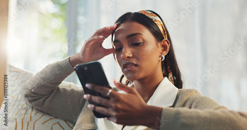 Fototapeta Woman, phone and stress in home with reading breakup message, fake news and online scam for identity fraud