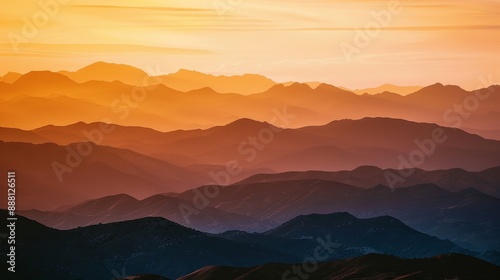 Wallpaper Mural Wide shot of a mountain range at sunset, bathed in warm hues. Torontodigital.ca