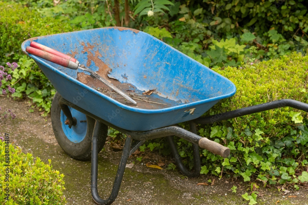 blue wheelbarrow with hedge trimmer blue wheelbarrow with hedge trimmer