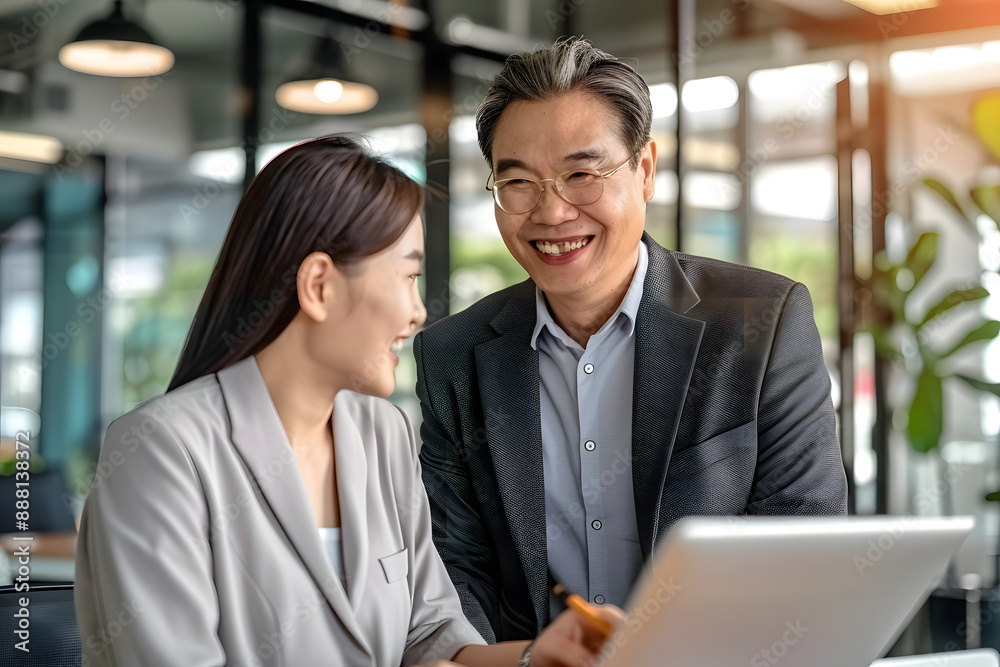 two happy asian business people meeting at the office two happy asian business people meeting at the office