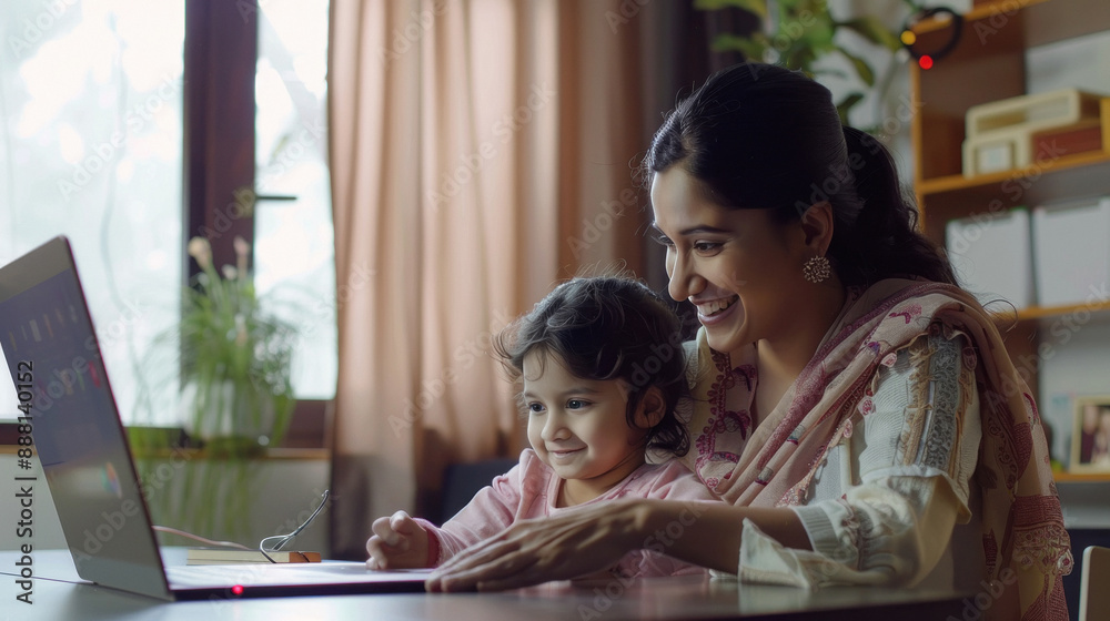 indian mother and daughter using laptop at home indian mother and daughter using laptop at home
