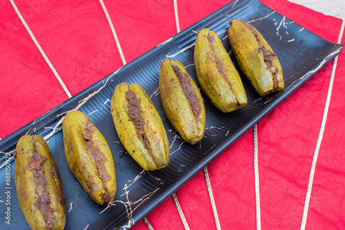 Indian Dry sabzi or side dish for roti or rice.  Stuffed Parwal or  Pointed Gourd .  photo