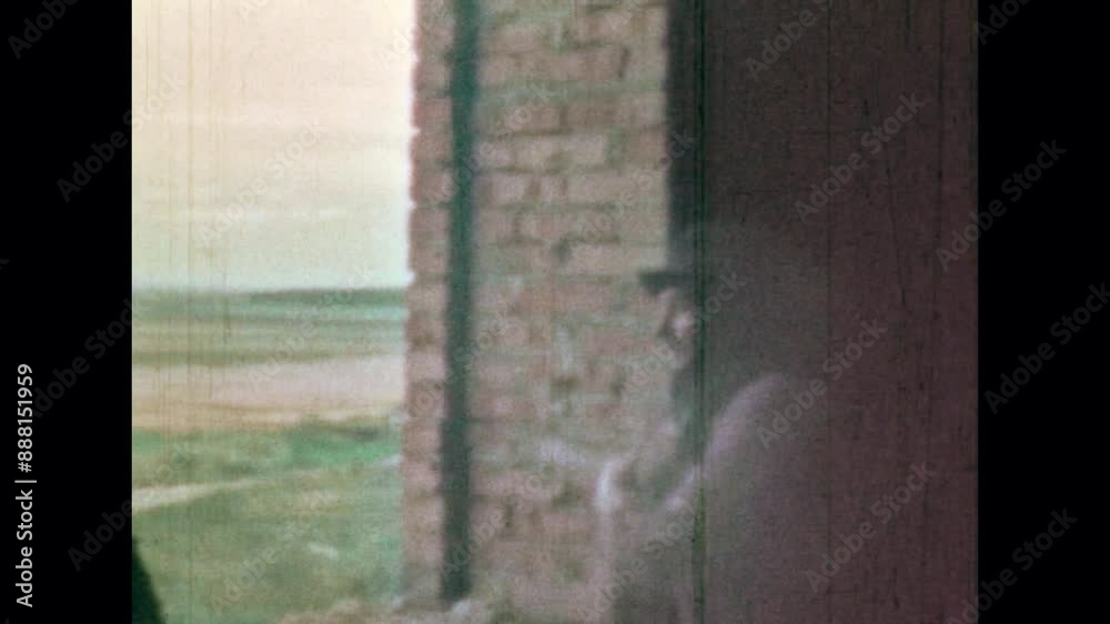 Cowboy buddies met in abandoned building on green natural valley background. Old Western style. Man starting play guitar, singing song. Vintage color film. Wild west archive. Grunge retro 1960s movie