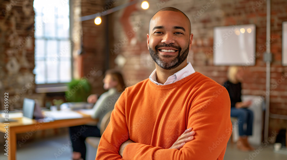 Fototapeta premium a man in an orange sweater with his arms crossed