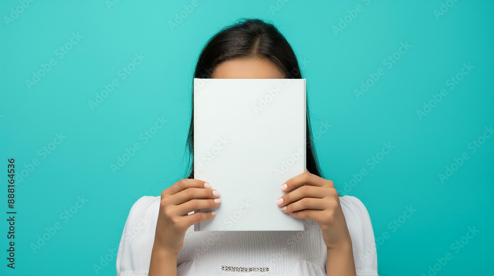 Young woman hiding behind book against turquoise background. Copy space. Generative AI Young woman hiding behind book against turquoise background. Copy space. Generative AI