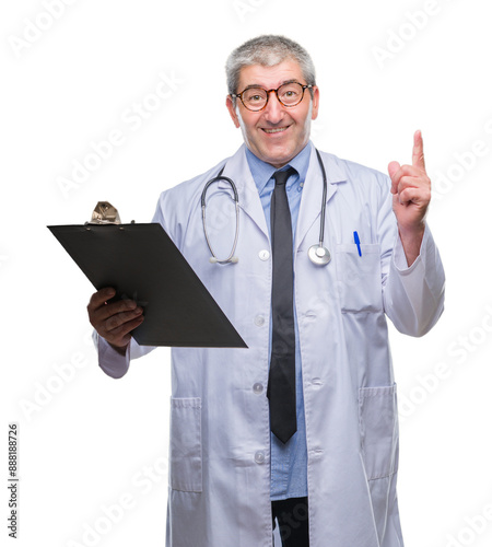 Handsome senior doctor man holding clipboard over isolated background surprised with an idea or question pointing finger with happy face, number one