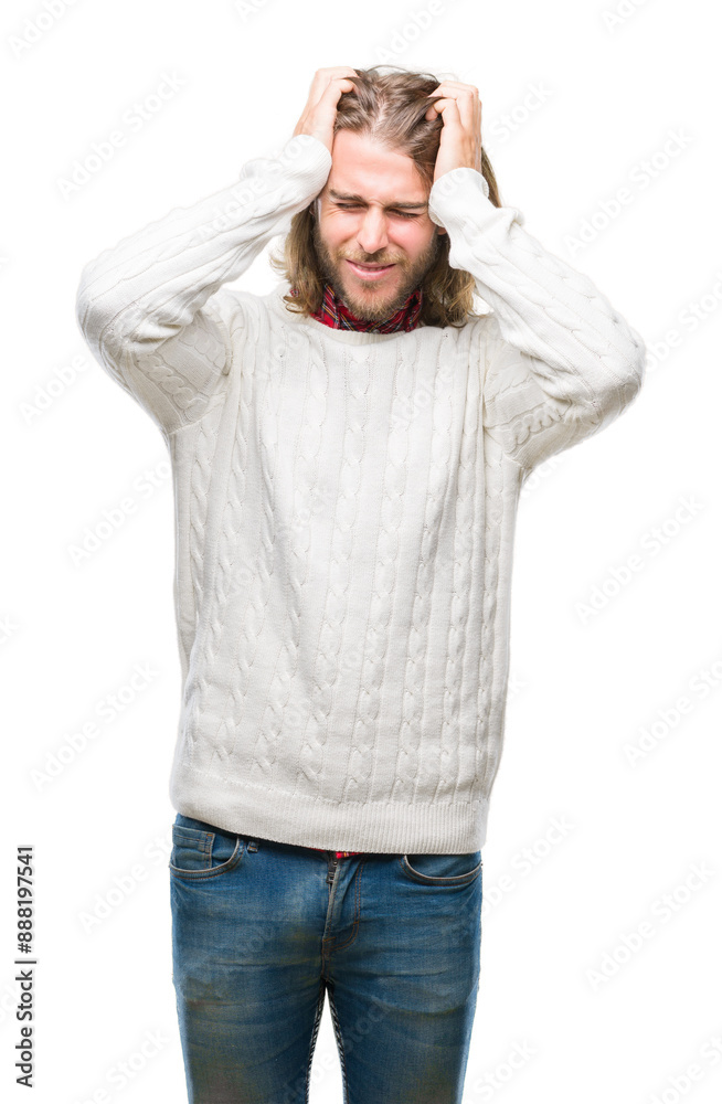 Young handsome man with long hair wearing winter sweater over isolated background suffering from headache desperate and stressed because pain and migraine. Hands on head.