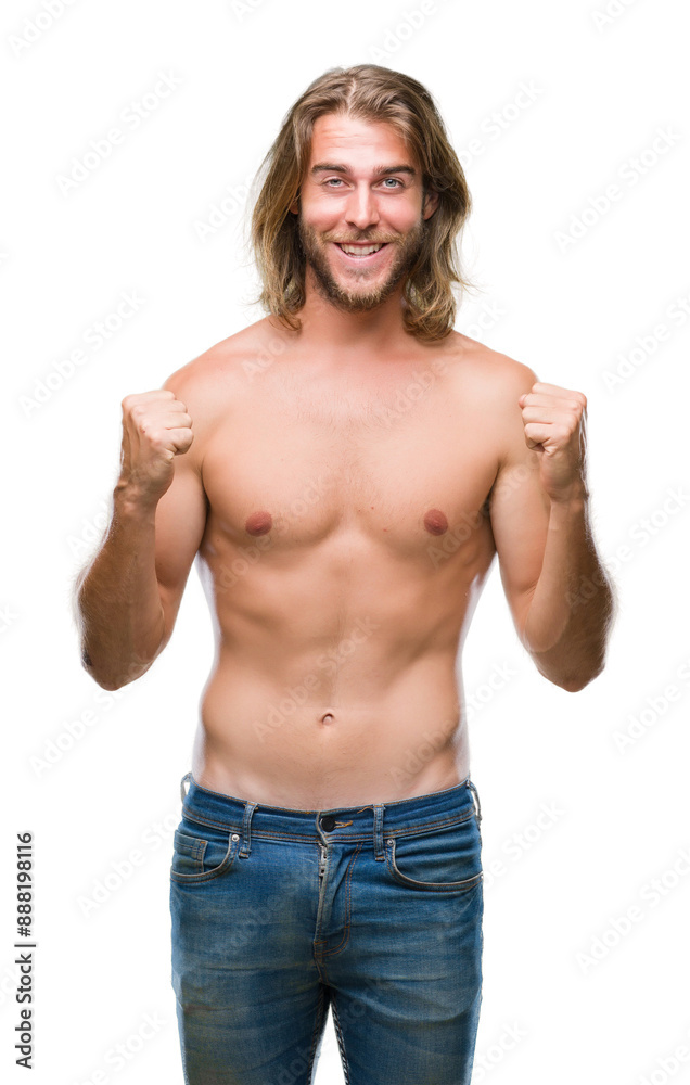Fototapeta premium Young handsome shirtless man with long hair showing sexy body over isolated background celebrating surprised and amazed for success with arms raised and open eyes. Winner concept.