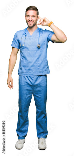 Handsome doctor man wearing medical uniform over isolated background Smiling pointing to head with one finger, great idea or thought, good memory