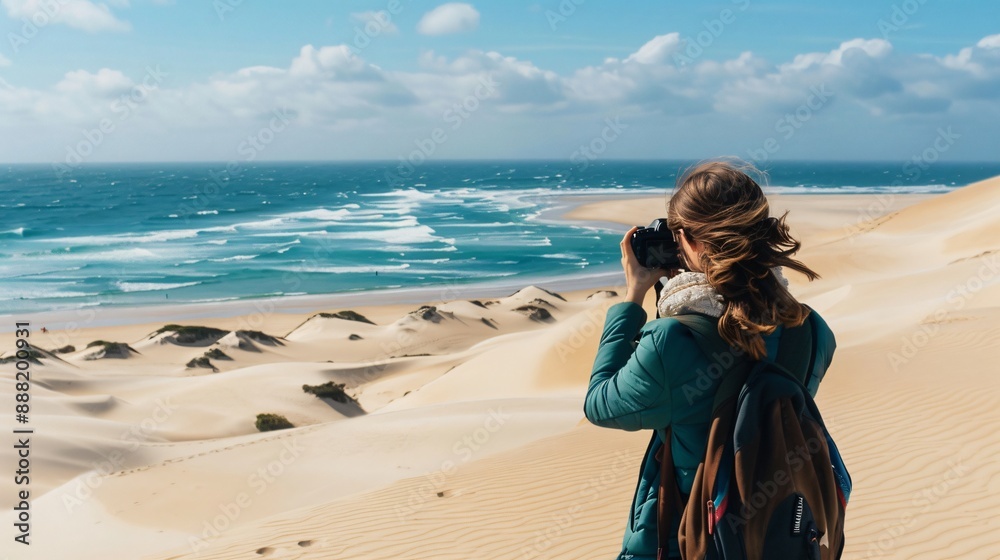 A woman capturing photos of the sea and sand dunes, embracing her love for photography A woman capturing photos of the sea and sand dunes, embracing her love for photography