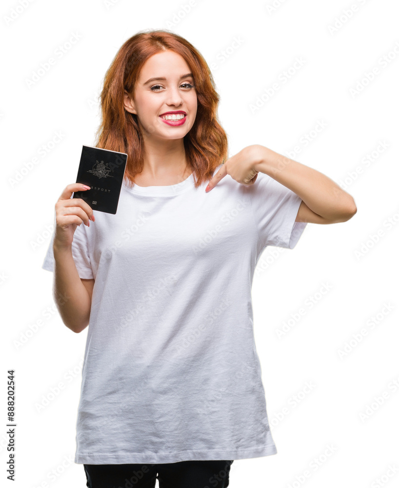 Young beautiful woman holding passport of australia over isolated background with surprise face pointing finger to himself Young beautiful woman holding passport of australia over isolated background with surprise face pointing finger to himself
