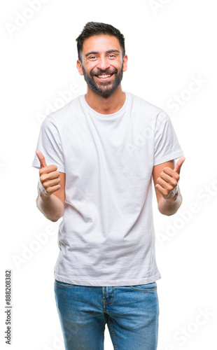 Adult hispanic man over isolated background success sign doing positive gesture with hand, thumbs up smiling and happy. Looking at the camera with cheerful expression, winner gesture.