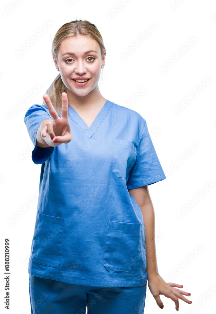 Young blonde surgeon doctor woman wearing medical uniform over isolated background smiling with happy face winking at the camera doing victory sign. Number two. Young blonde surgeon doctor woman wearing medical uniform over isolated background smiling with happy face winking at the camera doing victory sign. Number two.