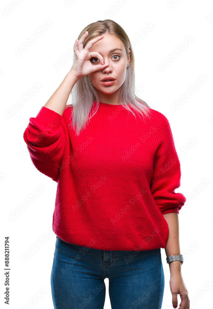 Young blonde woman wearing winter sweater over isolated background doing ok gesture shocked with surprised face, eye looking through fingers. Unbelieving expression. Young blonde woman wearing winter sweater over isolated background doing ok gesture shocked with surprised face, eye looking through fingers. Unbelieving expression.