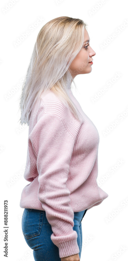 Young blonde woman wearing winter sweater over isolated background looking to side, relax profile pose with natural face with confident smile. Young blonde woman wearing winter sweater over isolated background looking to side, relax profile pose with natural face with confident smile.