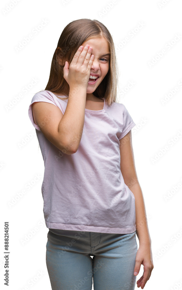 Young beautiful girl over isolated background covering one eye with hand with confident smile on face and surprise emotion.