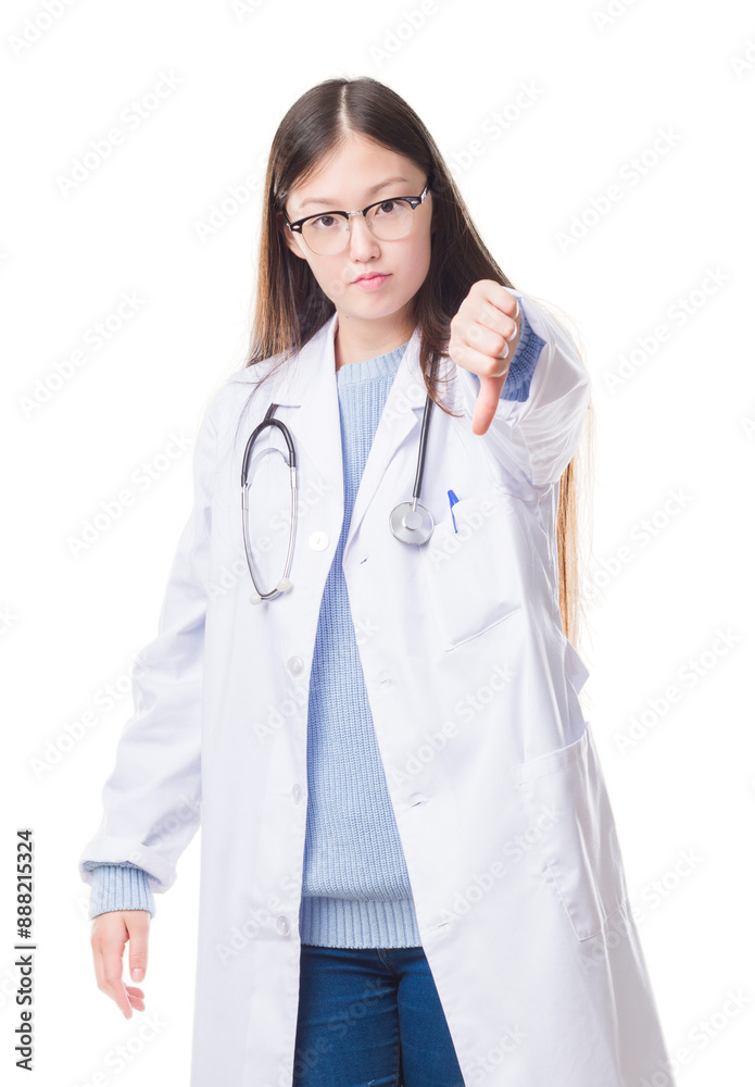 Young Chinese doctor woman over isolated background looking unhappy and angry showing rejection and negative with thumbs down gesture. Bad expression. Young Chinese doctor woman over isolated background looking unhappy and angry showing rejection and negative with thumbs down gesture. Bad expression.