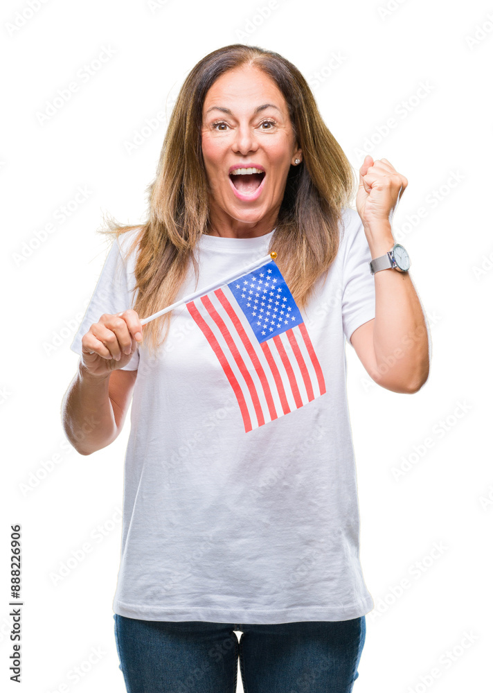 Middle age hispanic woman holding flag of United States of America over isolated background screaming proud and celebrating victory and success very excited, cheering emotion Middle age hispanic woman holding flag of United States of America over isolated background screaming proud and celebrating victory and success very excited, cheering emotion