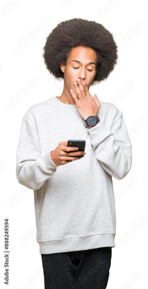 Young african american man with afro hair using a smartphone cover mouth with hand shocked with shame for mistake, expression of fear, scared in silence, secret concept Young african american man with afro hair using a smartphone cover mouth with hand shocked with shame for mistake, expression of fear, scared in silence, secret concept