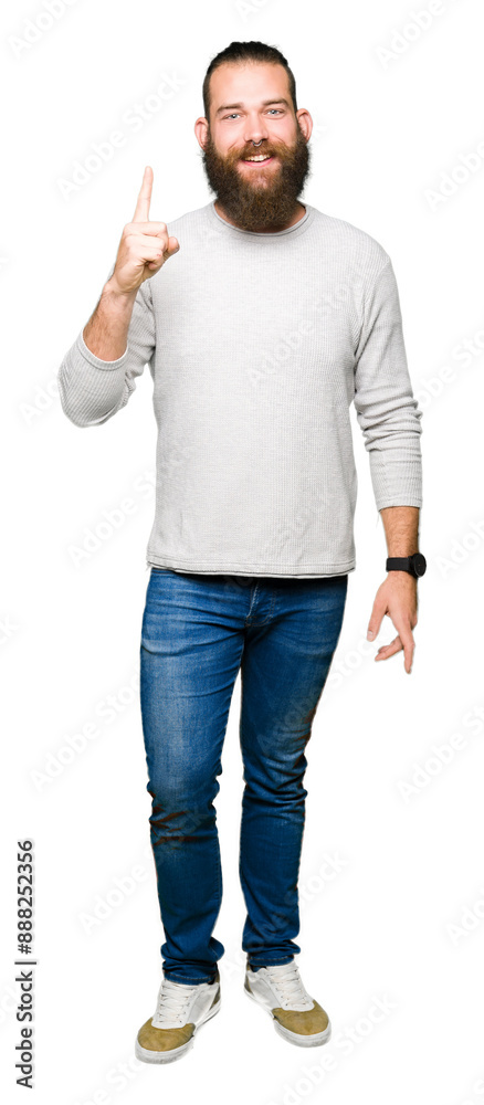 Young blond man wearing casual sweater showing and pointing up with finger number one while smiling confident and happy. Young blond man wearing casual sweater showing and pointing up with finger number one while smiling confident and happy.