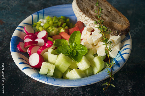 Healthy greek salad in a ceramic bowl. Dark background