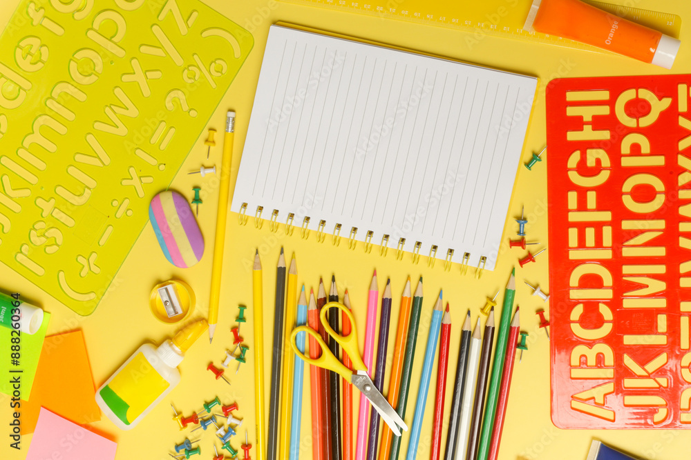 Back to school concept with variety of office and school supplies on yellow background. Back to school concept with variety of office and school supplies on yellow background.