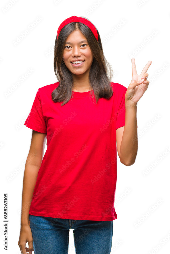 Young asian woman over isolated background smiling with happy face winking at the camera doing victory sign. Number two. Young asian woman over isolated background smiling with happy face winking at the camera doing victory sign. Number two.