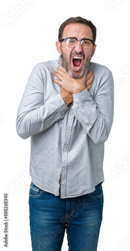 Handsome middle age elegant senior man wearing glasses over isolated background shouting and suffocate because painful strangle. Health problem. Asphyxiate and suicide concept.