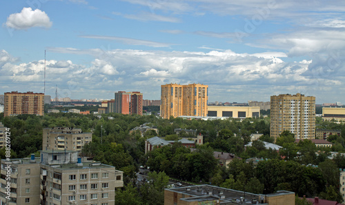 Cityscape - panoramic top view of a residential quarter with modern high-rise buildings with green trees on a sunny summer day and blue sky with white clouds in Reutov, Moscow region and copy space photo