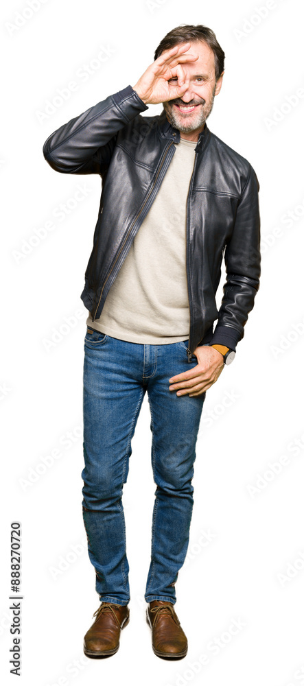 Middle age handsome man wearing black leather jacket doing ok gesture with hand smiling, eye looking through fingers with happy face. Middle age handsome man wearing black leather jacket doing ok gesture with hand smiling, eye looking through fingers with happy face.