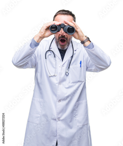 Middle age senior hoary doctor man looking through binoculars isolated background scared in shock with a surprise face, afraid and excited with fear expression