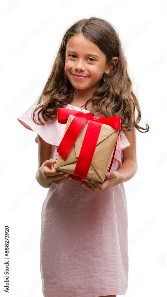 Brunette hispanic girl holding a gift with a happy face standing and smiling with a confident smile showing teeth Brunette hispanic girl holding a gift with a happy face standing and smiling with a confident smile showing teeth