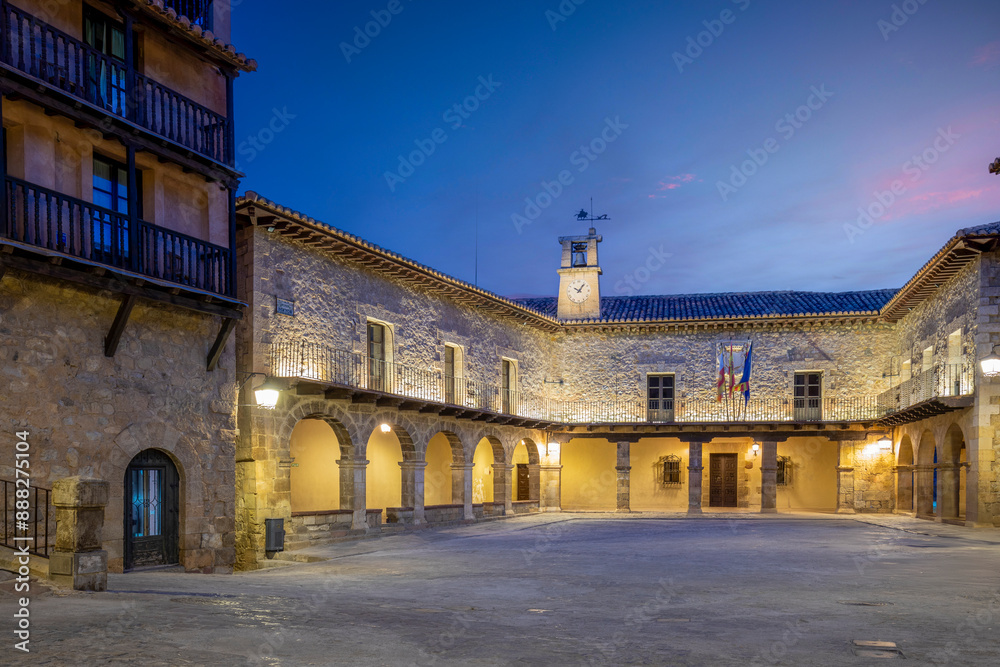 View of the Plaza Mayor of Albarracín, Teruel, Aragon, Spain, illuminated at dusk with the porticoed town hall as the protagonist View of the Plaza Mayor of Albarracín, Teruel, Aragon, Spain, illuminated at dusk with the porticoed town hall as the protagonist