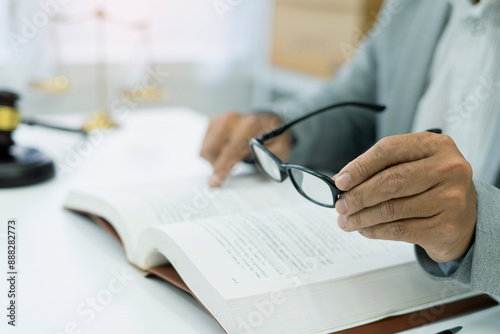 university student prepares for exams in a library, engrossed in legal studies with books and glasses, dedicated to gaining knowledge and academic success. photo