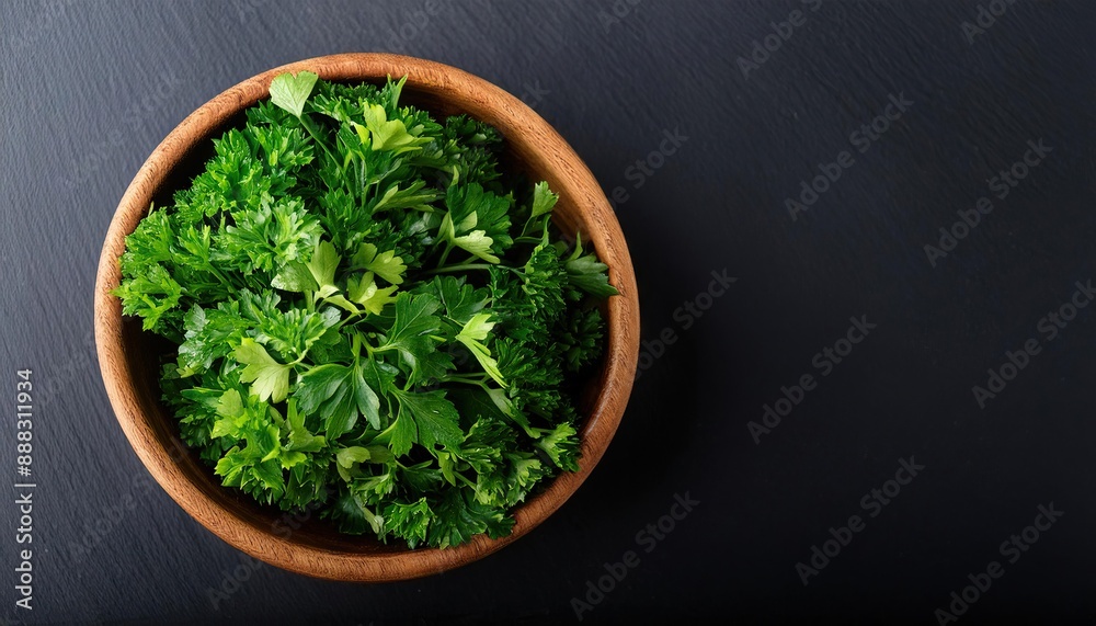 parsley in a bowl on a black background, top view, copy space parsley in a bowl on a black background, top view, copy space