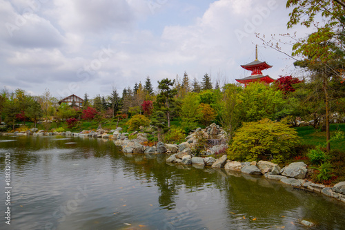 A beautiful Japanese garden with a pond and Tahoto Pagoda in the distance. Japanese garden in the public park of the city of Krasnodar, Russia.